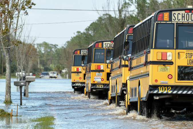 shutterstock_2376824867_school buses in flood